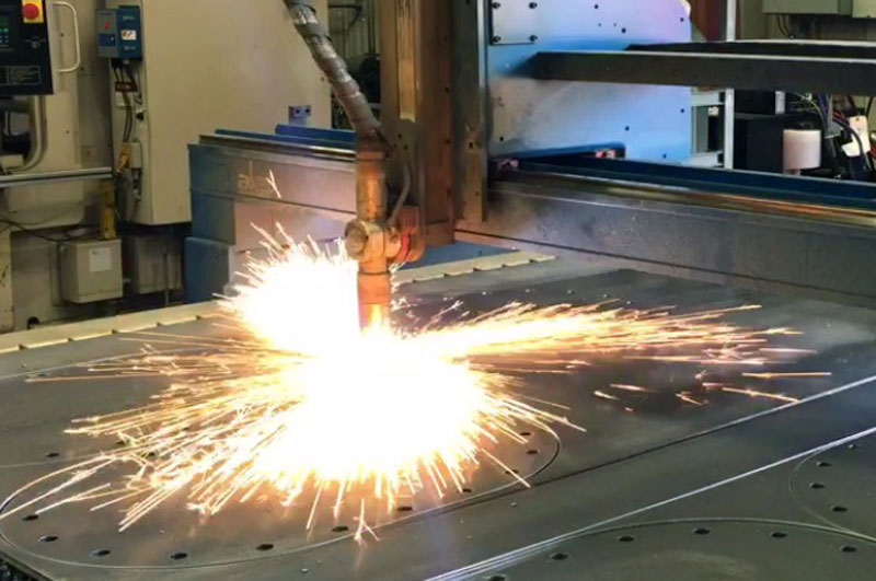image of our plasma cutter cutting steel and throwing sparks