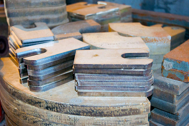 image of cut metal parts stacked up to show our ability to complete our work